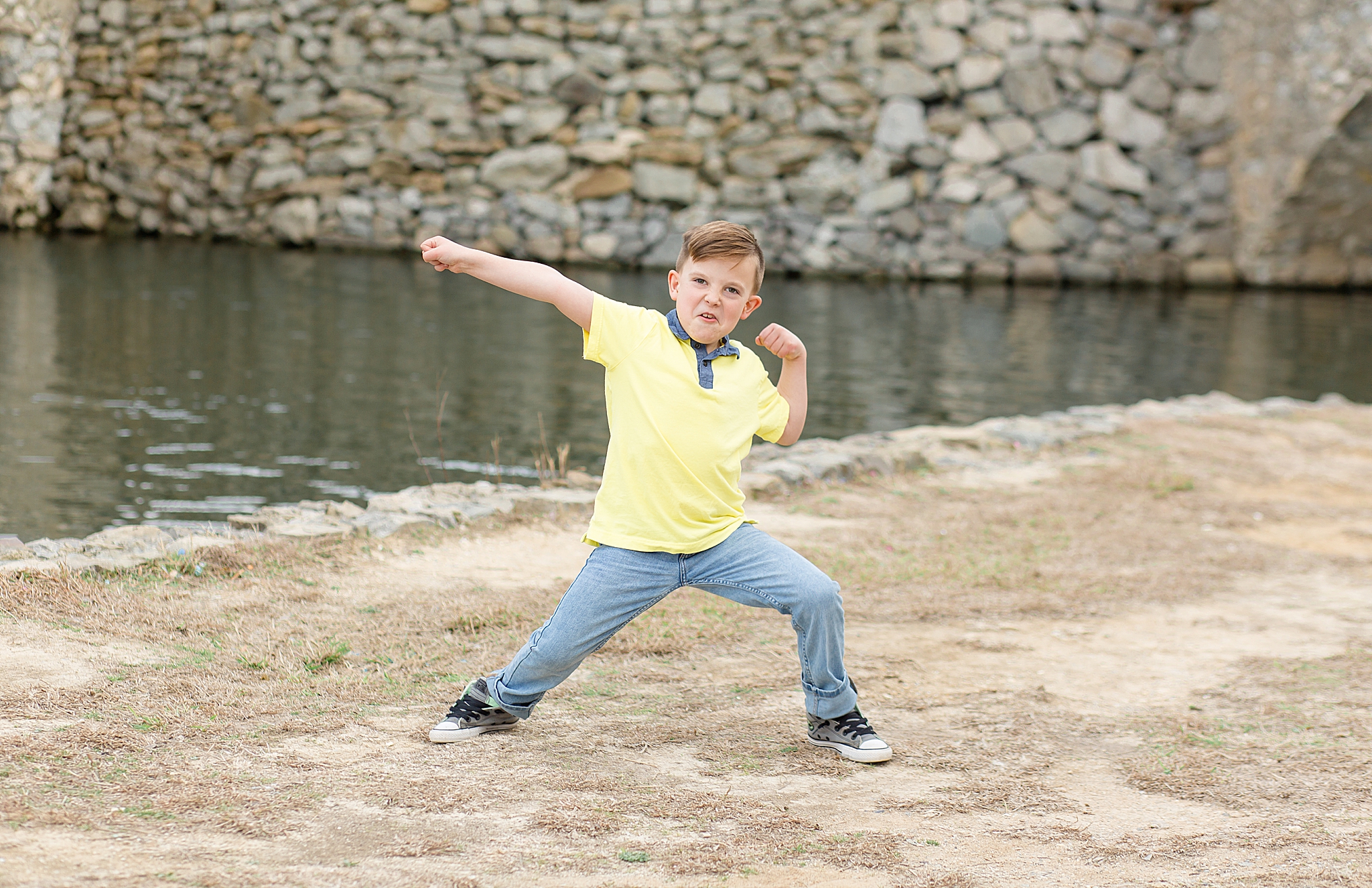 young son poses playfully during family photos in Dallas