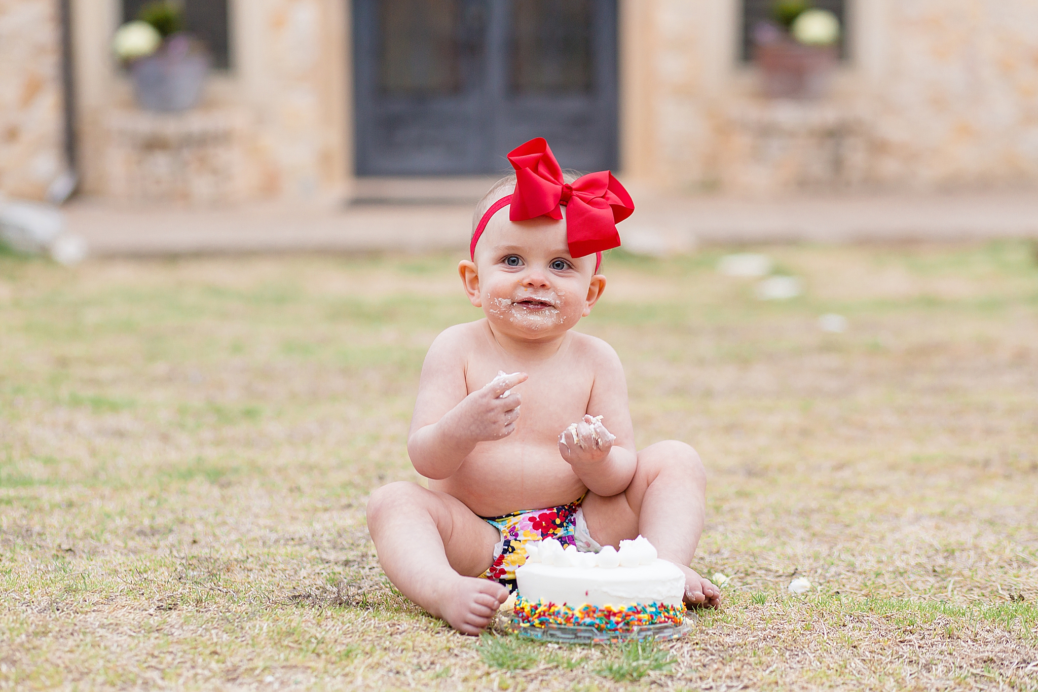 Toddler enjoys smash cake for one year old in McKinney, Tx captured by McKinney family photographer 