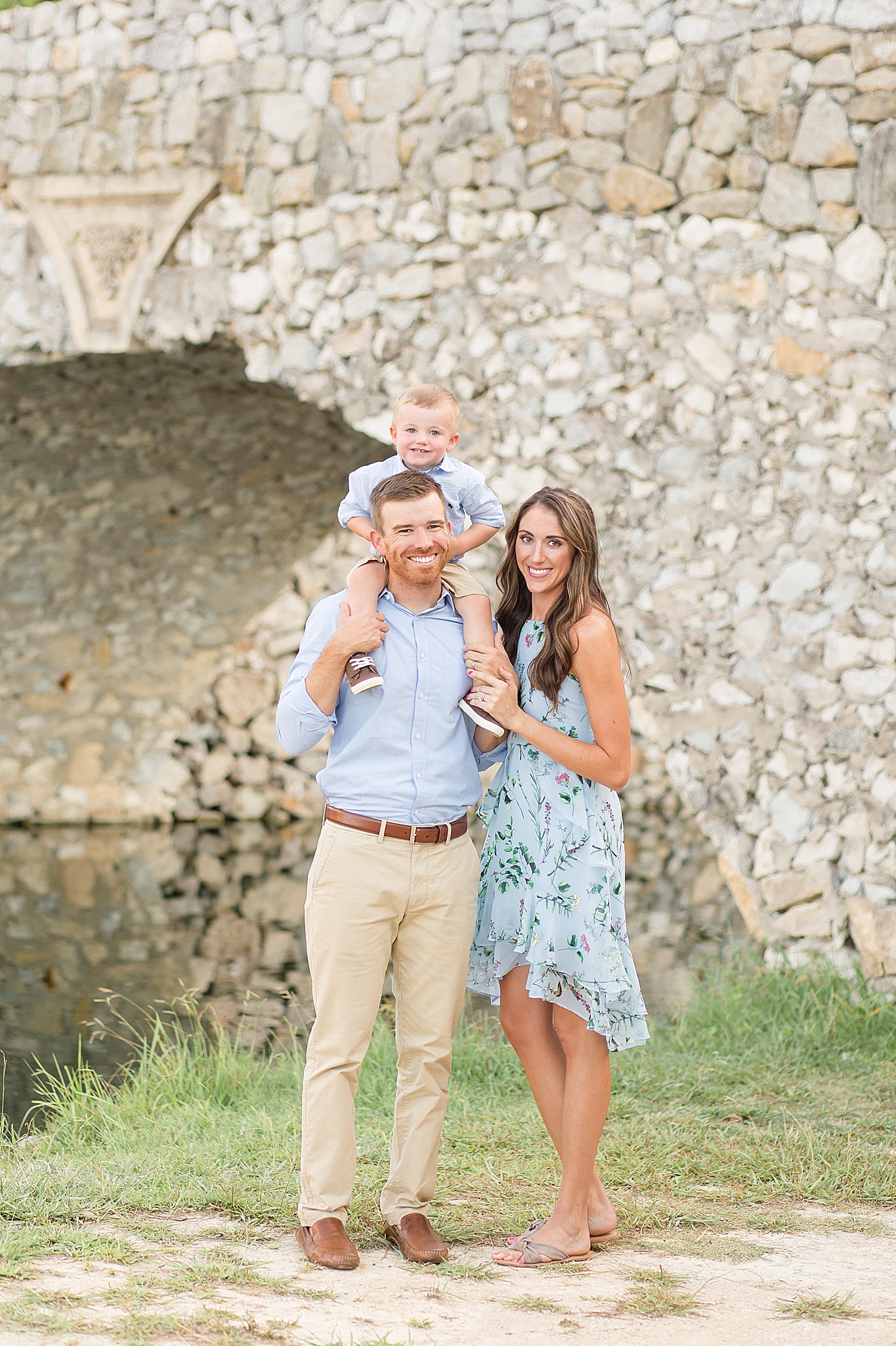 family of three poses during McKinney family portraits