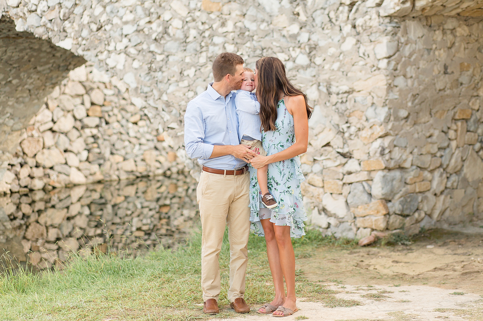 parents kiss son during McKinney family portraits captured by McKinney Photographer Wisp + Willow Photography Co. 