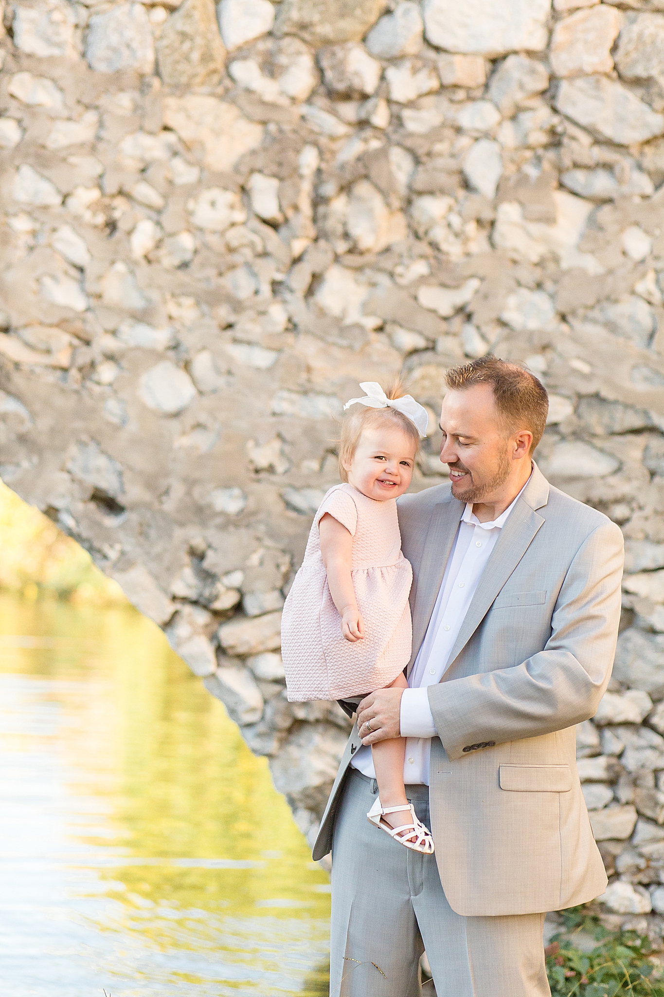 dad holds daughter in pink dress during TX family photos