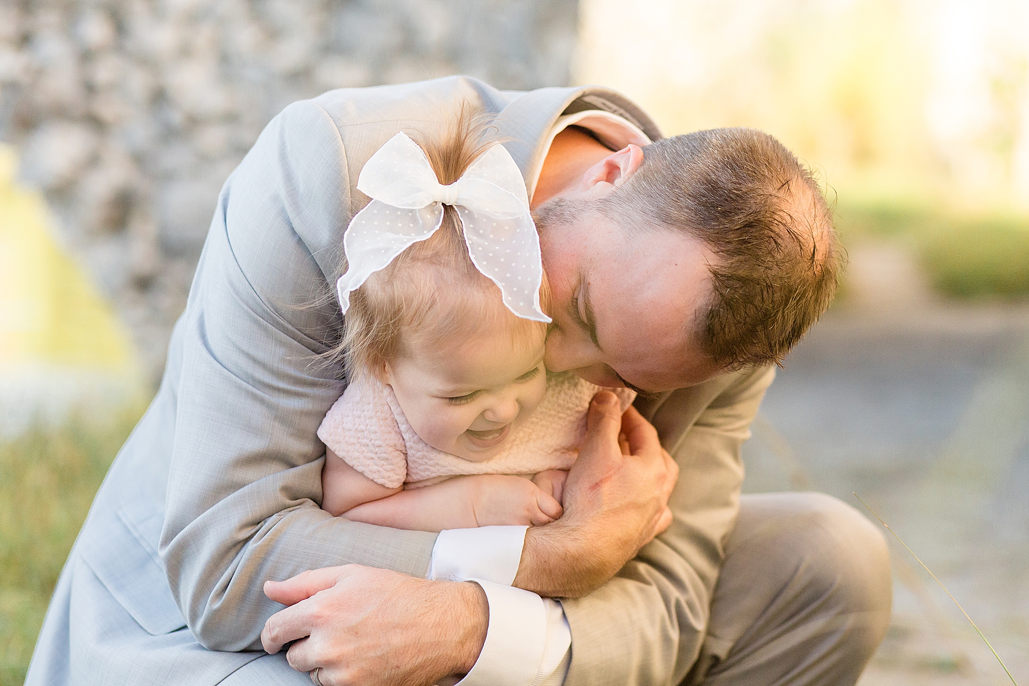 dad hugs daughter during Spring Adriatica Village family portraits