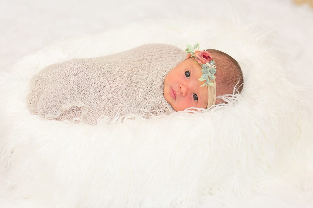 baby girl looks at camera during lifestyle newborn session with dallas newborn photographer Wisp + Willow Photography Co.
