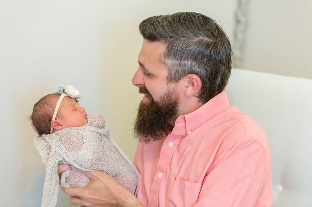 Dad holds newborn baby girl during Dallas newborn session with Dallas newborn photographer Wisp + Willow Photography Co. 