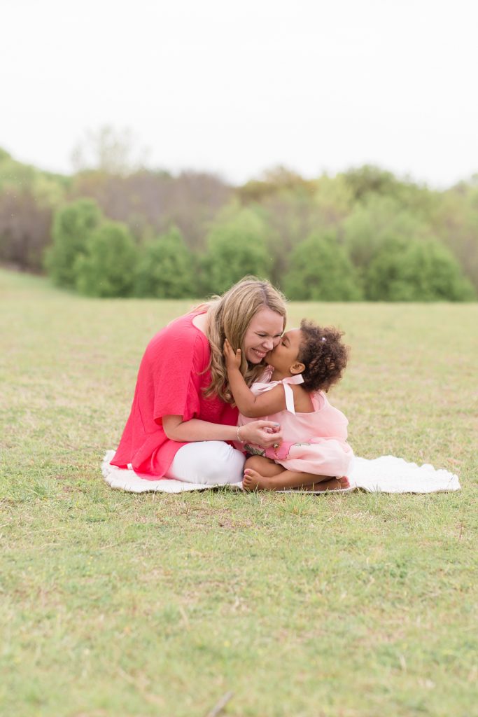 girl kisses mom on the cheek during mommy and me session with Wisp + Willow Photography Co in McKinney, TX