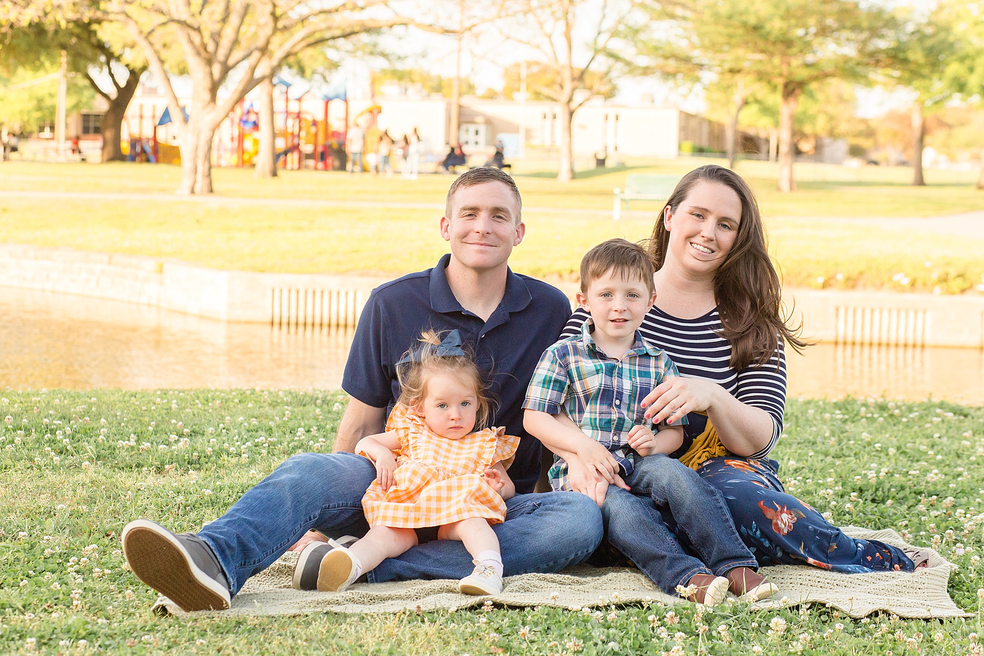family of 4 poses for spring portrait session with Wisp + Willow Photography Co. in Plano, TX.