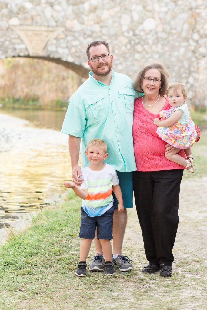 grandma poses with son and kids for family spring portrait session with Wisp + Willow Photography Co.
