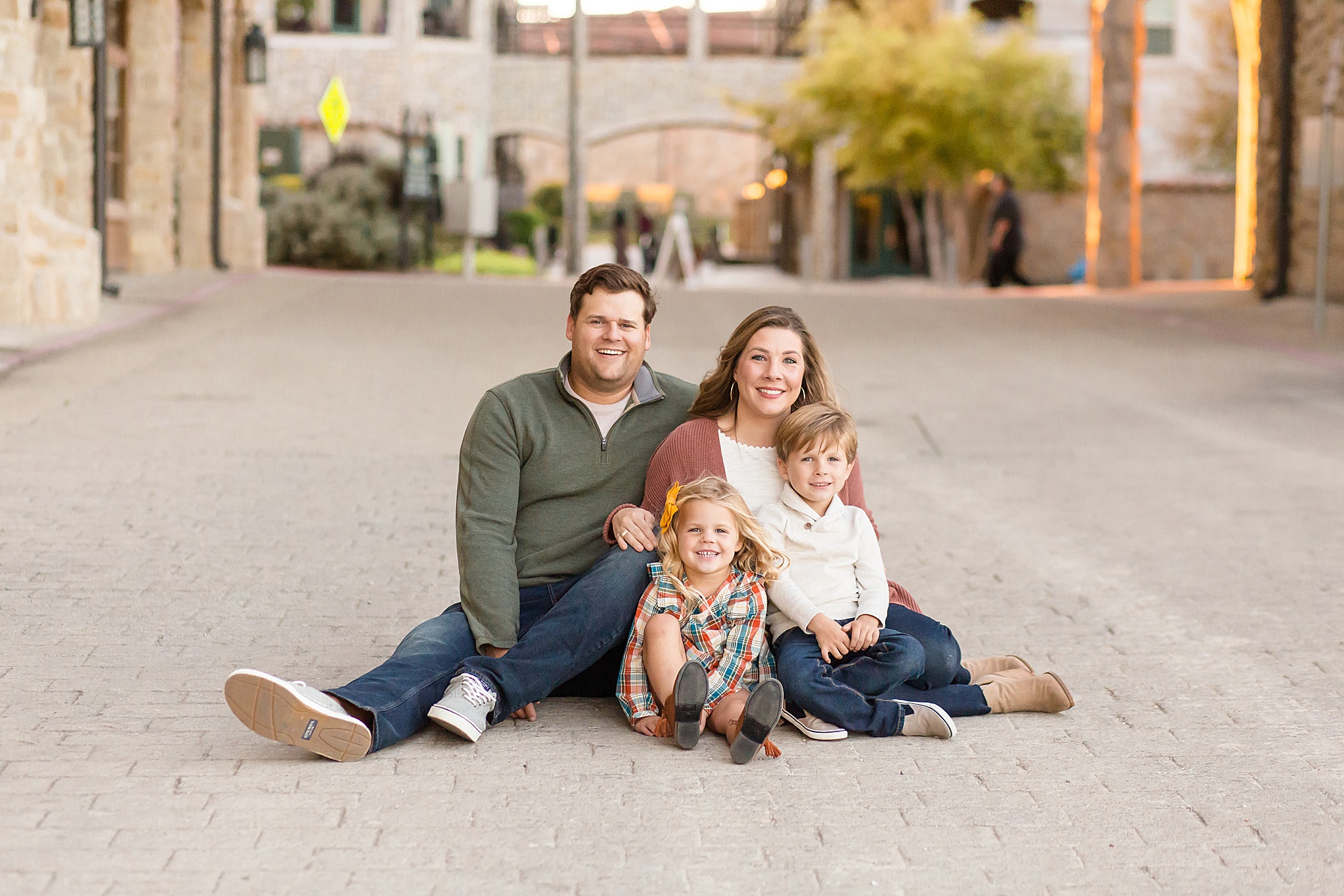 family of four poses for fall family portrait session with wisp + willow photography co.