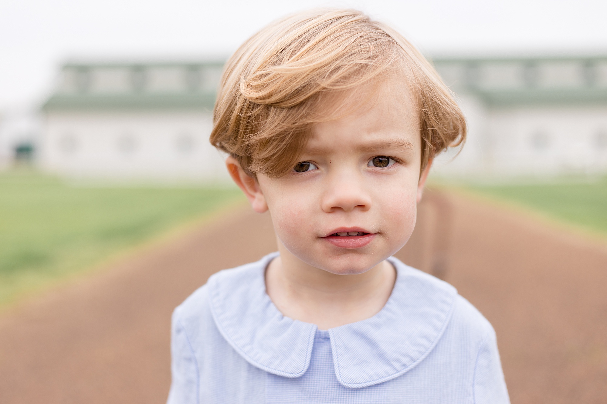 boy looks at camera during family portrait session with Wisp + Willow Photography Co.