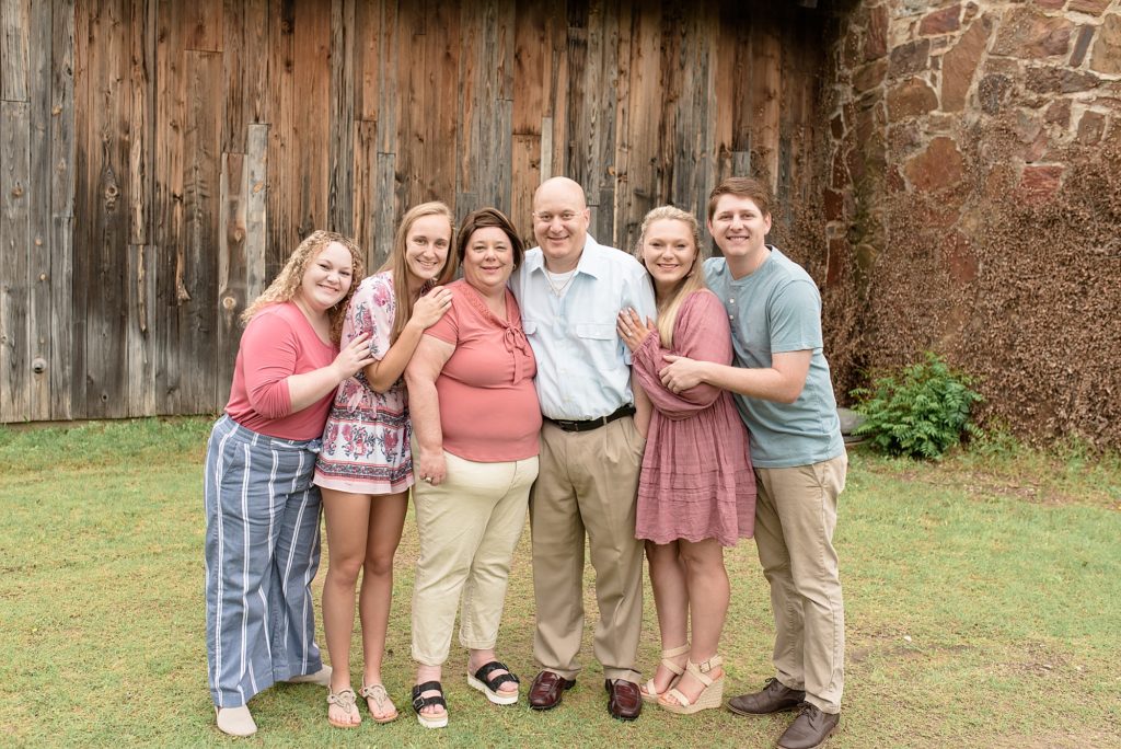 family stands in front of barn at Frisco heritage Museum for family session with Wisp + Willow Photography Co. 