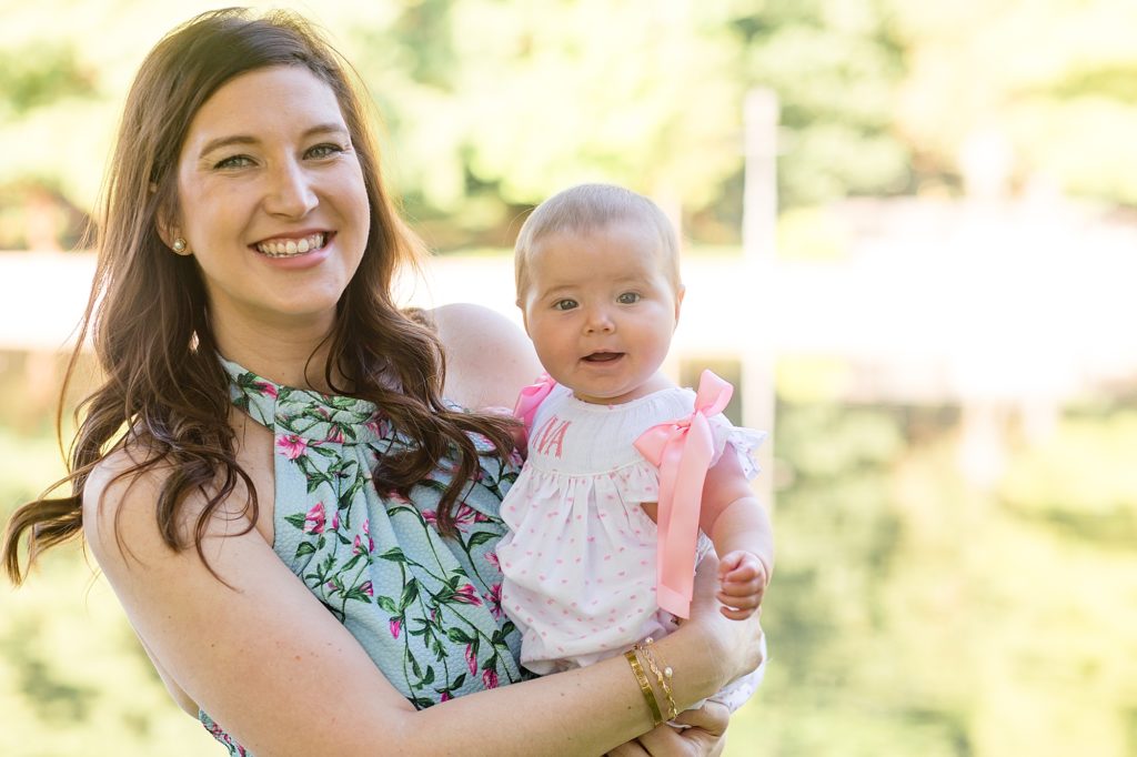 mom holds daughter during spring family portrait session at Lakeside Park with Wisp + Willow Photography Co. 