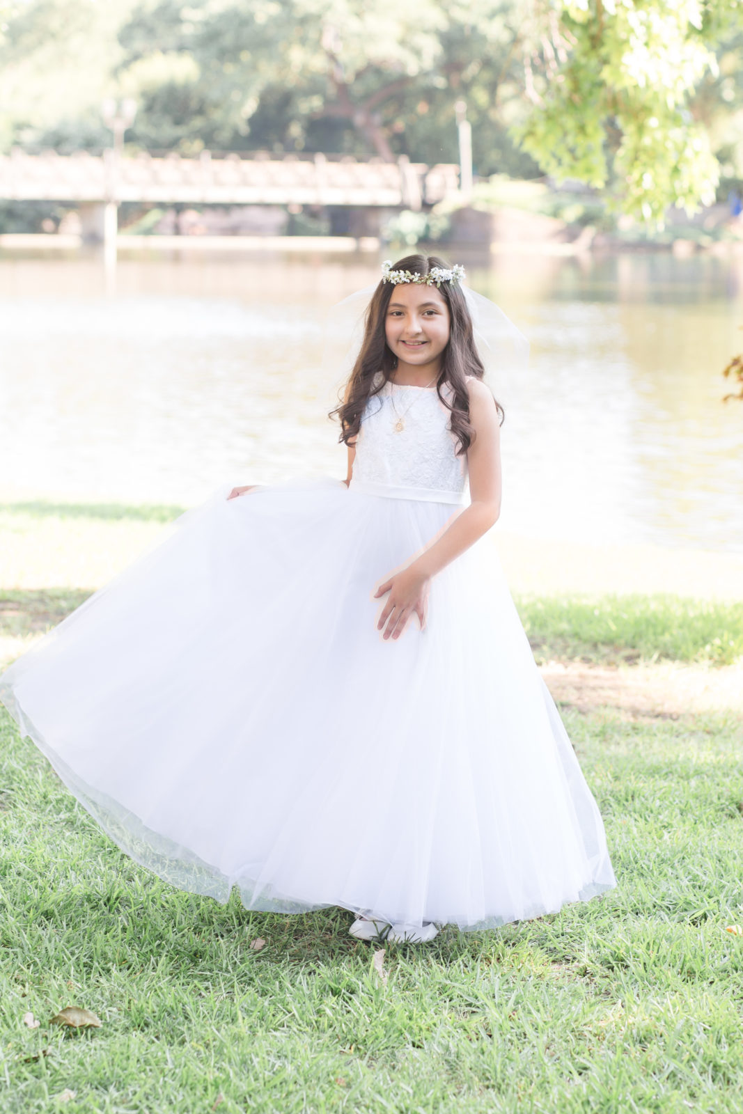 Little girl in communion dress poses during celebration portrait session with Dallas event photographer Wisp + Willow Photography Co. 