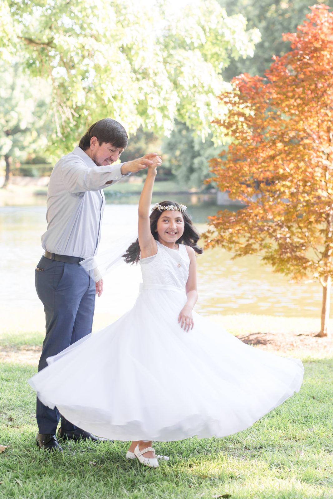 Dad twirls daughter around during family portraits with dallas family photographer Wisp + Willow Photography Co. 