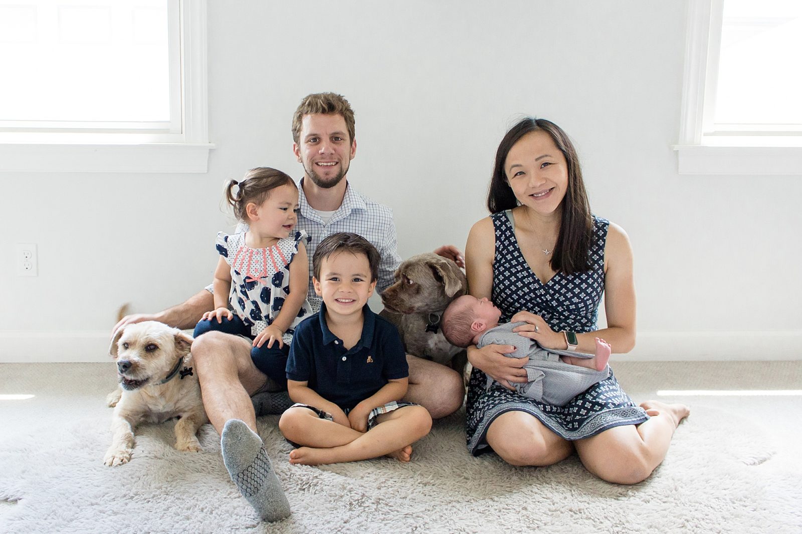 Family of 5 poses in nursery with family dogs during lifestyle newborn session with Brentwood family photographer Wisp + Willow Photography Co. 