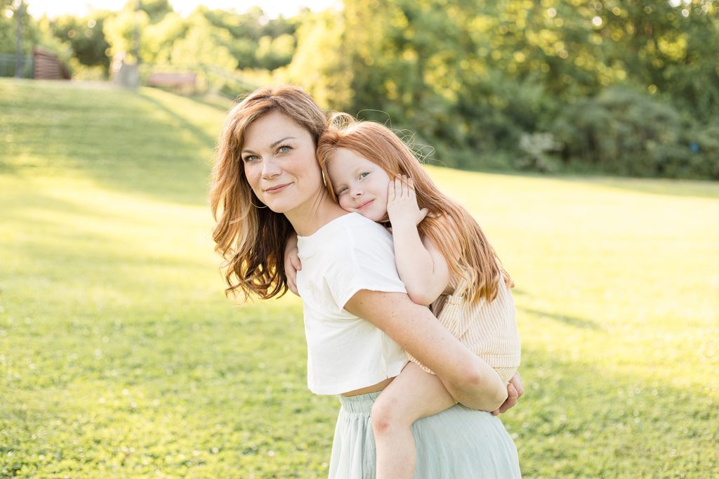 Mom holds daughter in field at Pinkerton Park with Franklin family photographer Wisp + Willow Photography Co. 