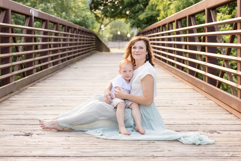 Little boy sit in mom's lap during family portrait session at Pinkerton Park with Franklin family photographer Wisp + Willow Photography Co. 