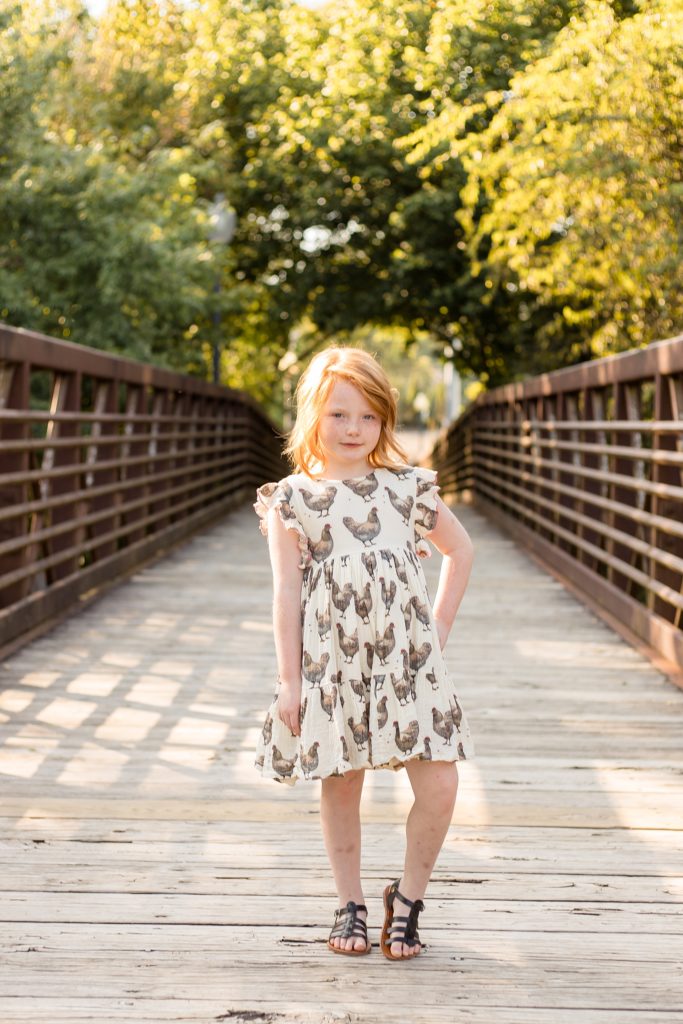 little girl poses for fall mini sessions at Pinkerton Park in Franklin TN with family photographer Wisp + Willow Photography Co.