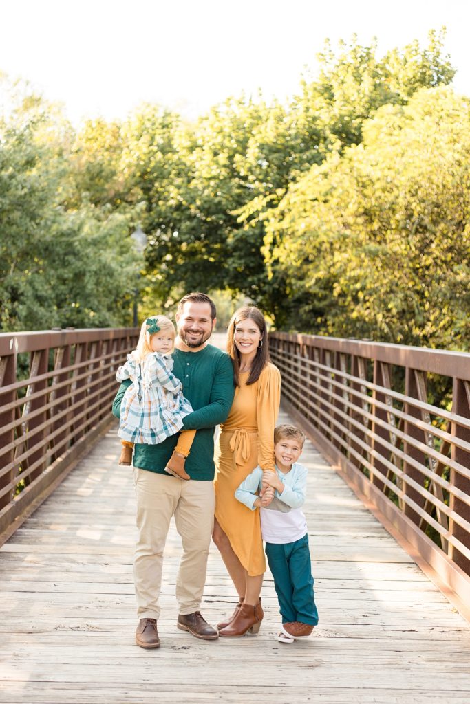 family smiles for camera at Pinkerton Park for fall mini session with Wisp + Willow Photography Co.
