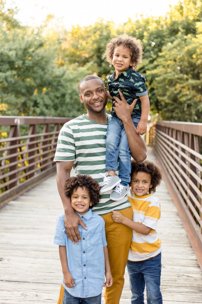 Dad poses with 3 sons for fall mini session a pinkerton park