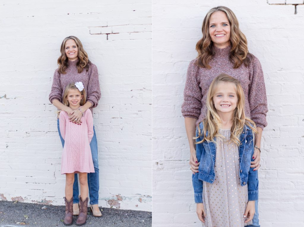 Mom poses with daughters in front of white wall in the historic downtown McKinney Square for family portrait session with Wisp + Willow Photography Co. Click to see more from this session!
