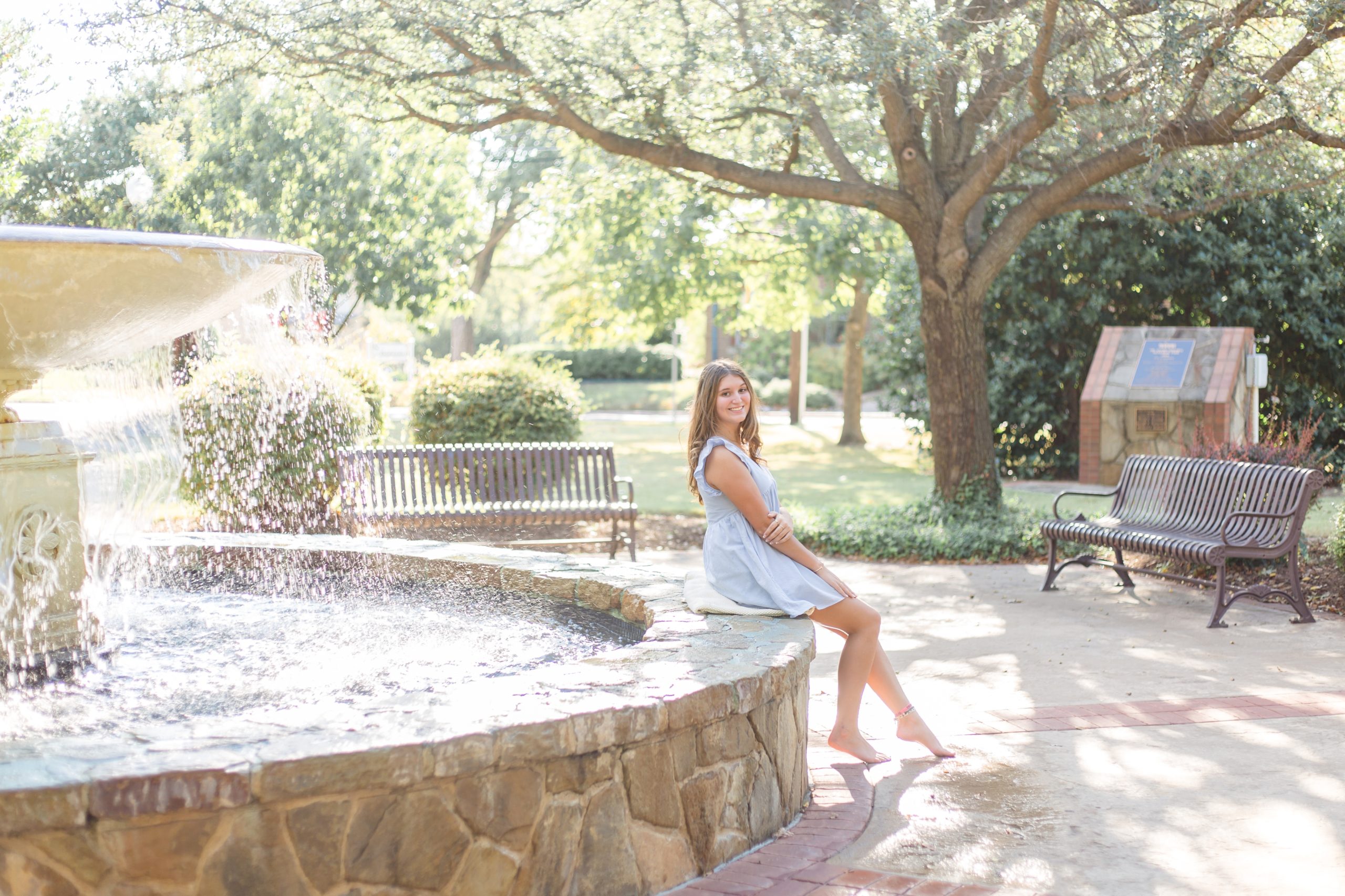 Hope's senior session was a blast! Our favorite photo from this session is of her in a blue sundress sitting on a fountain outside of the historic Downtown McKinney Square. Click to see more from this senior session by Wisp + Willow Photography Co.