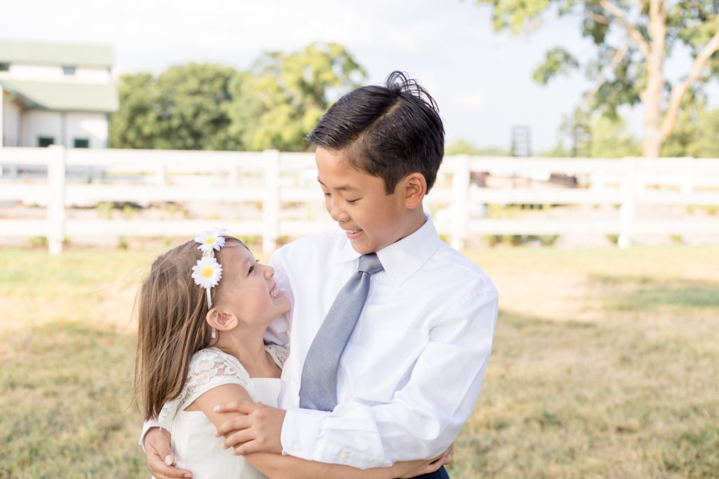Siblings pose for family portrait session with Wisp + Willow Photography Co. Click to see more from this session on our blog.
