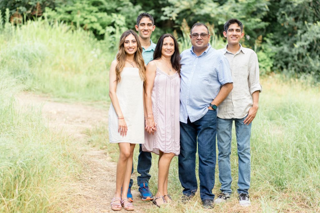 Family poses together during extended family portrait session in the spring at Arbor Hills Nature Preserve in Plano, TX with family photography team Wisp + Willow Photography Co. Click to see more from this sweet session on our blog now! 