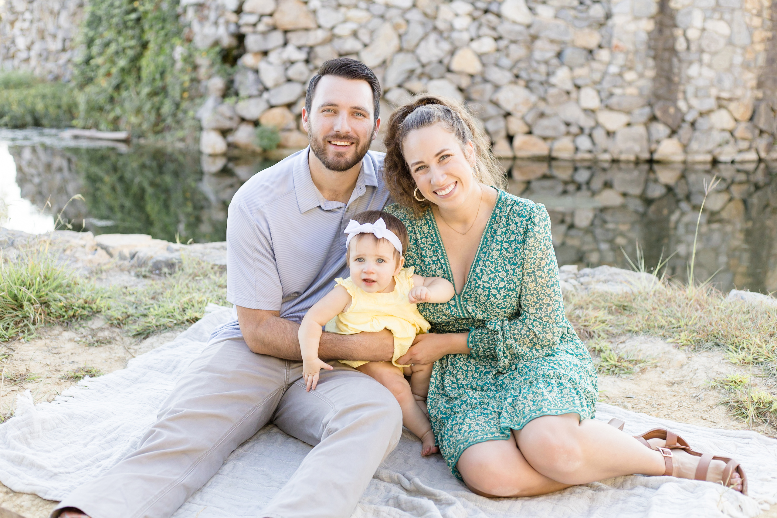 Family of 3 poses for mini session at Adriatica Village in McKinney, TX in the fall. Click to read about why we think Minis are good for you!