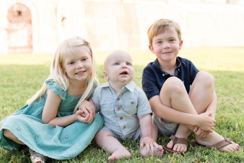 Siblings pose during family portrait session with family photography team Wisp + Willow Photography Co. at Adriatica Village in McKinney, TX. Click to see more from this sweet session live on the blog now!