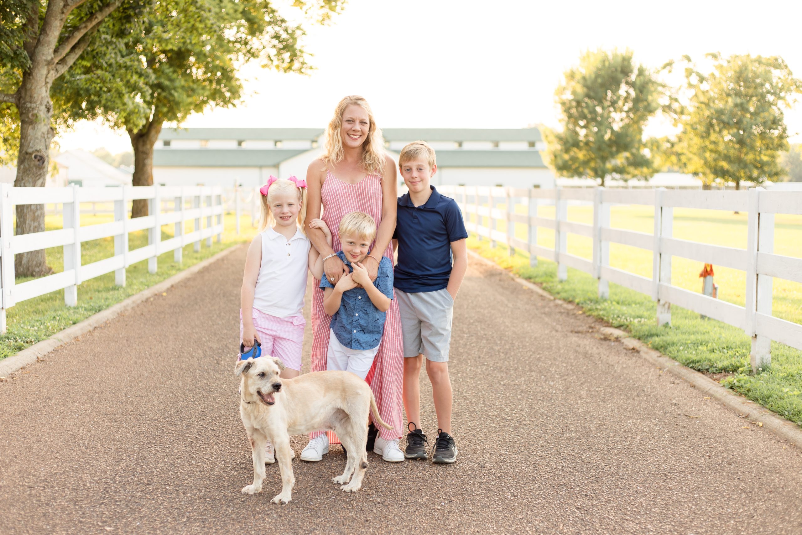 Mom, children and pup pose in front of Harlinsdale Farm in Franklin, TN for mommy and me portrait session with Wisp + Willow Photography Co. Click to see more from this sweet session on our blog now!