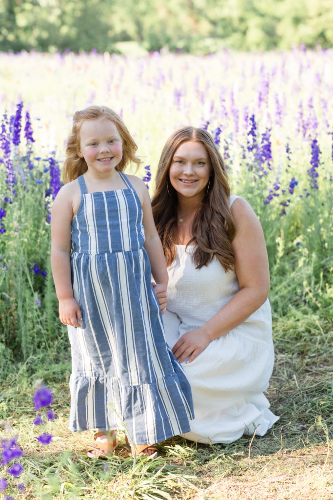 Mom and daughter pose in wildflowers during mommy and me session with Dallas Photographer Wisp + Willow Photography Co. 
