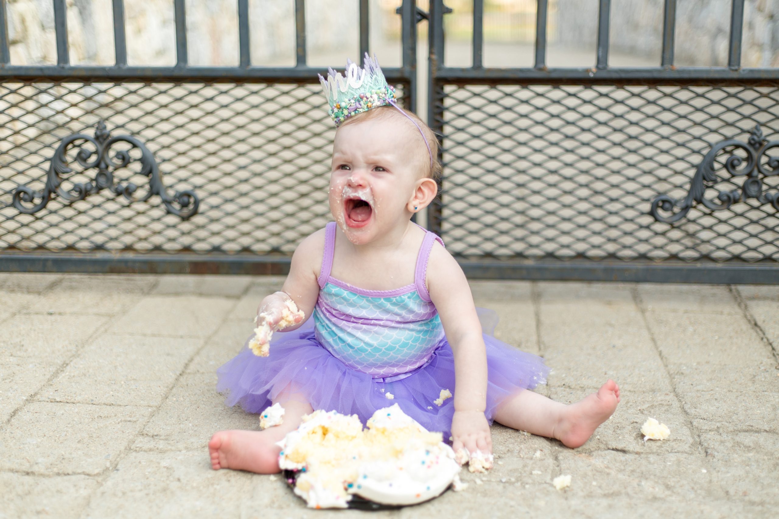 Baby girl poses with her one year smash cake during session with family photography team Wisp + Willow Photography Co. Today on the blog we're talking about why choosing a full session might be best for your family! Click to read more! 
