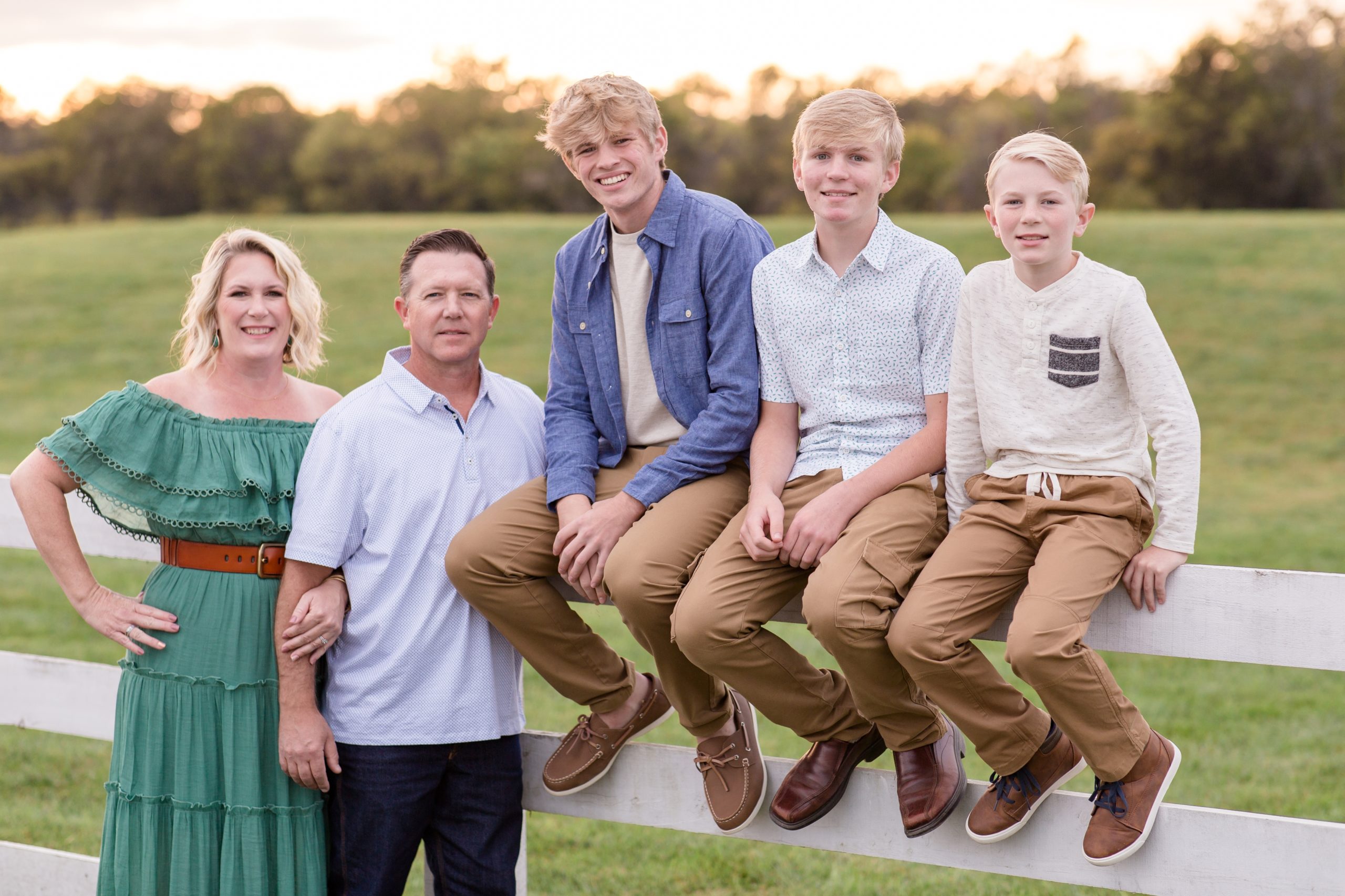 Family of 5 poses along white fence at Harlinsdale Farm during session with family photography team Wisp + Willow Photography Co. Click to learn more about why we love this session location! 
