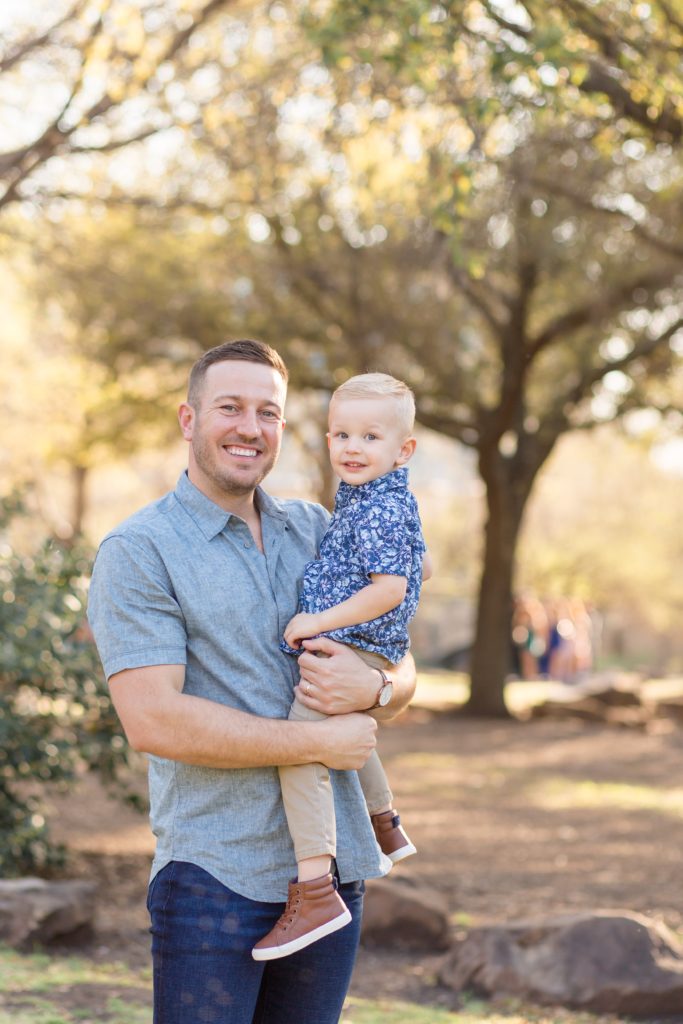 Dad holds son during family session with Frisco family photographer Wisp + Willow Photography Co