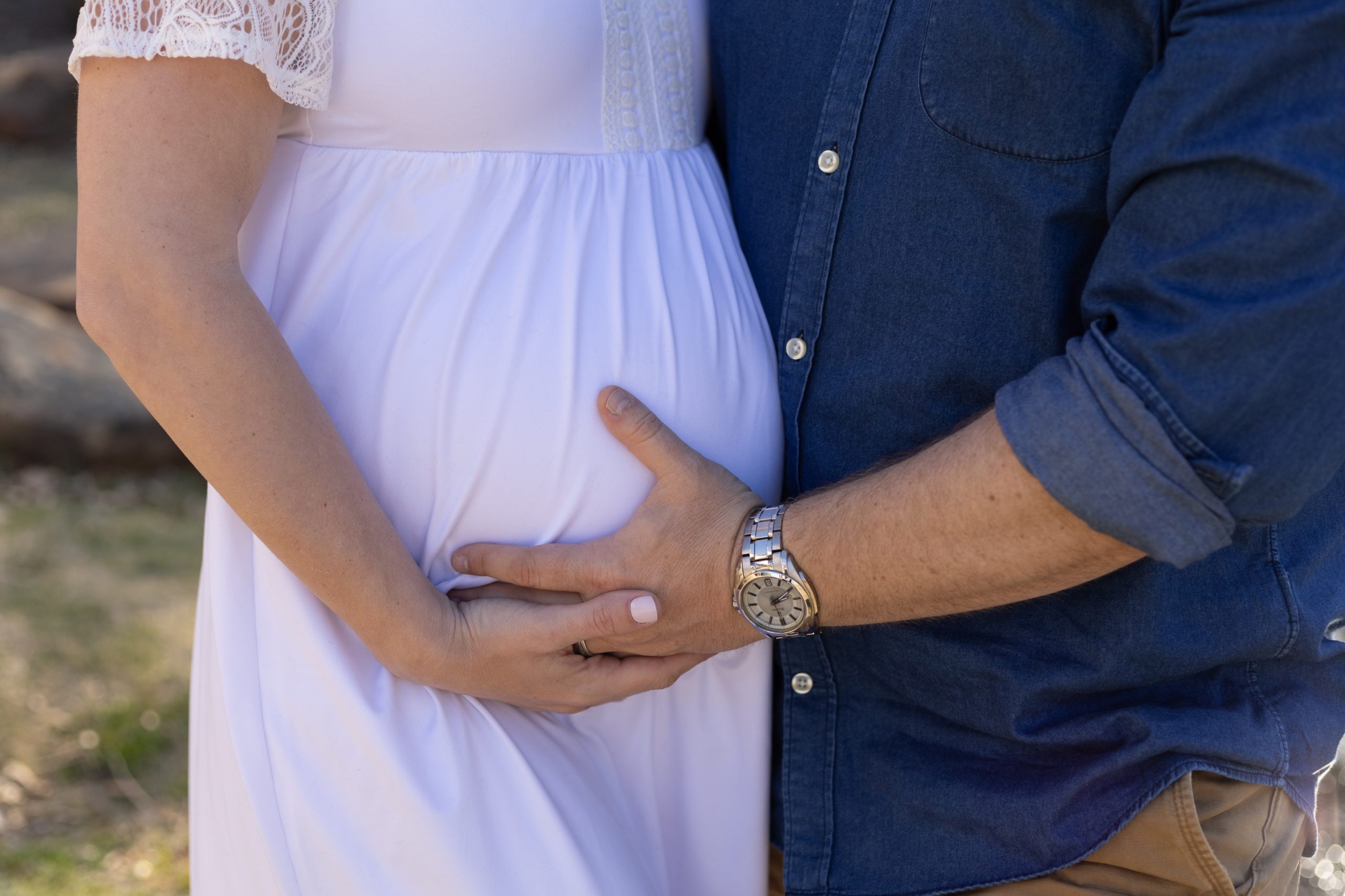 Dad holds moms pregnant belly during maternity session with family photography team Wisp + Willow Photography Co. Click to read more from this session live on the blog now.