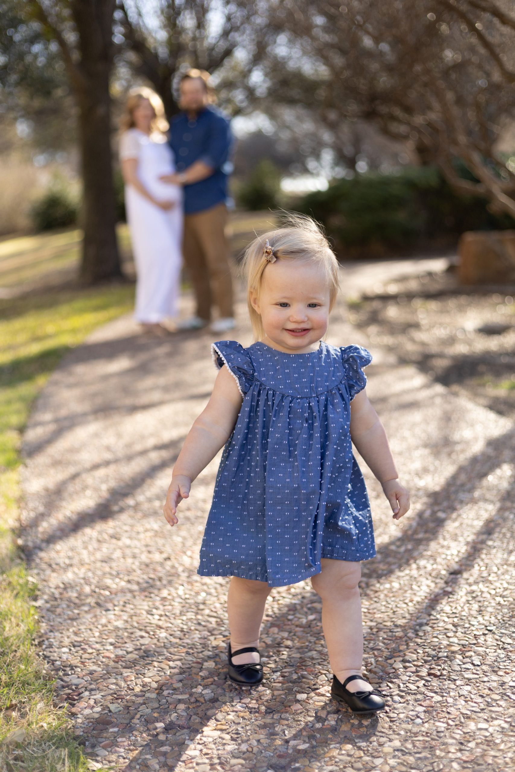 Daughter walks along path during maternity session with family photography team Wisp + Willow Photography Co. Click to read more from this session live on the blog now. 