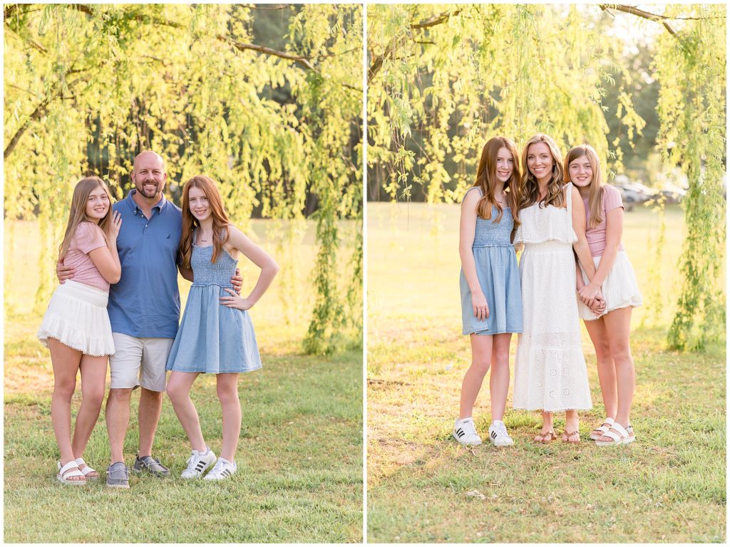 Daughters and mom and dad are seen here standing just beneath a gorgeous hanging tree.Daughter is wearing a blush pink short sleeve shirt with a white flutter skirt. Second daughtere is wearing a blue sleeveless knee length dress. Mom is wearing a sleeveless ankle length dress. Dad is wearing a short sleeve blue polo with khaki shorts. 