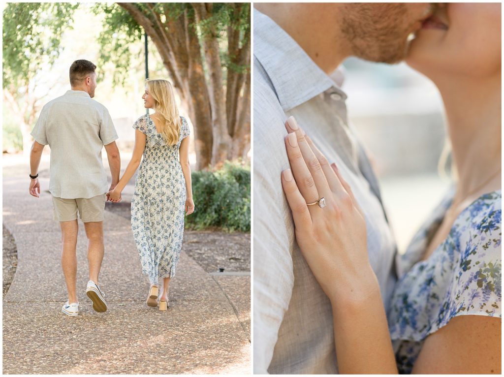Woman with blue floral dress and man with grey button up walk hand in hand down sidewalk lined with beautiful trees and sunlight during engagement photo session. 