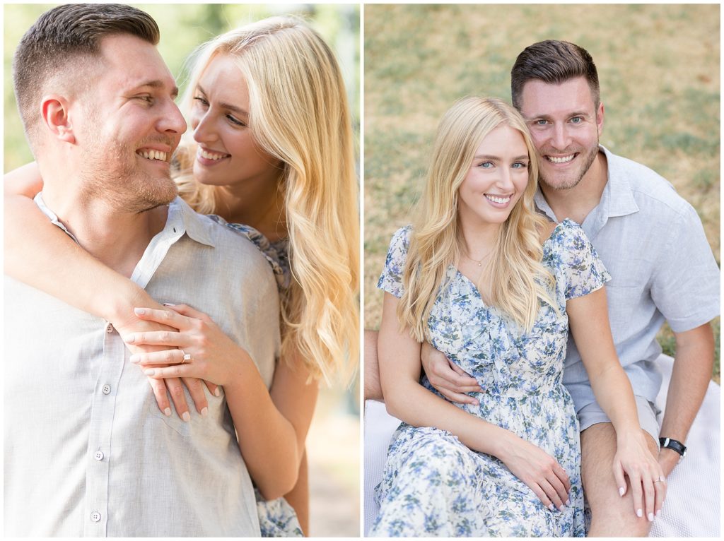Gorgeous blonde woman in blue floral dress and fiance in grey button down sit together outside in the summer time during engagement photo session. 