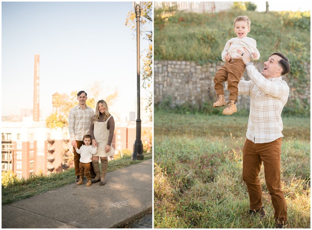 Family of 3 poses on sidewalk in front of city scape of Libby Hill in Richmond, VA. Dad lifts son up over head while wearing matching tan and brown shirt and pants during photo session with Wisp + Willow Photography Co. 