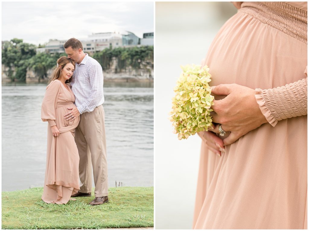 Husband in plaid shirt and tan khakis kisses expectant wife's head in Coolidge Park in front of Tennessee River during family maternity session. 