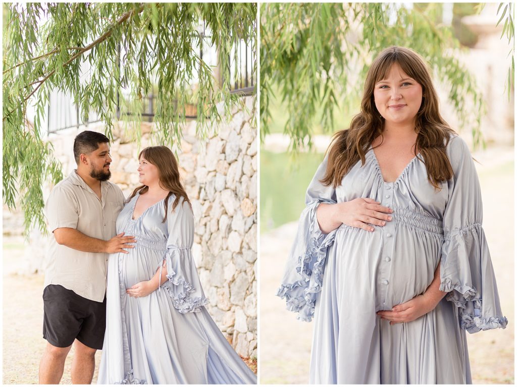 Pregnant woman and husband stand in front of rock wall while touching belly gently during maternity session.
