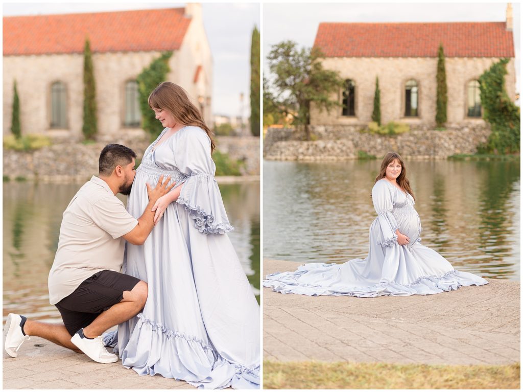 Woman in light blue flowy dress knees in front of pond and gently holds pregnant belly. Husband kisses wife's pregnant belly during maternity session with Wisp + Willow Photography Team. 