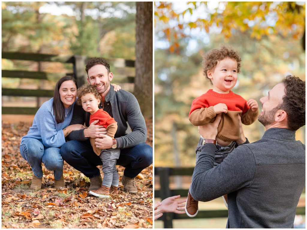 Mom and dad squat down and hug toddler son in red and brown sweater in Sims Lake Park during fall family photo session. Dad in grey sweater holds son in red and brown sweater with autumn trees in the background. 