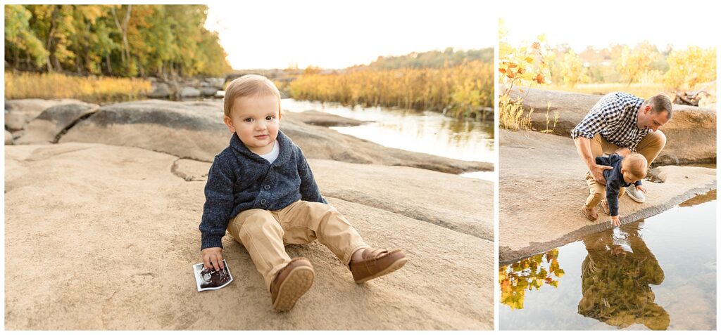 Toddler boy holds sonogram as he sits on rock during Richmond family photography session with Wisp + Willow Photography Co. Dad holds little boy over water in Belle Isle, Richmond, VA.