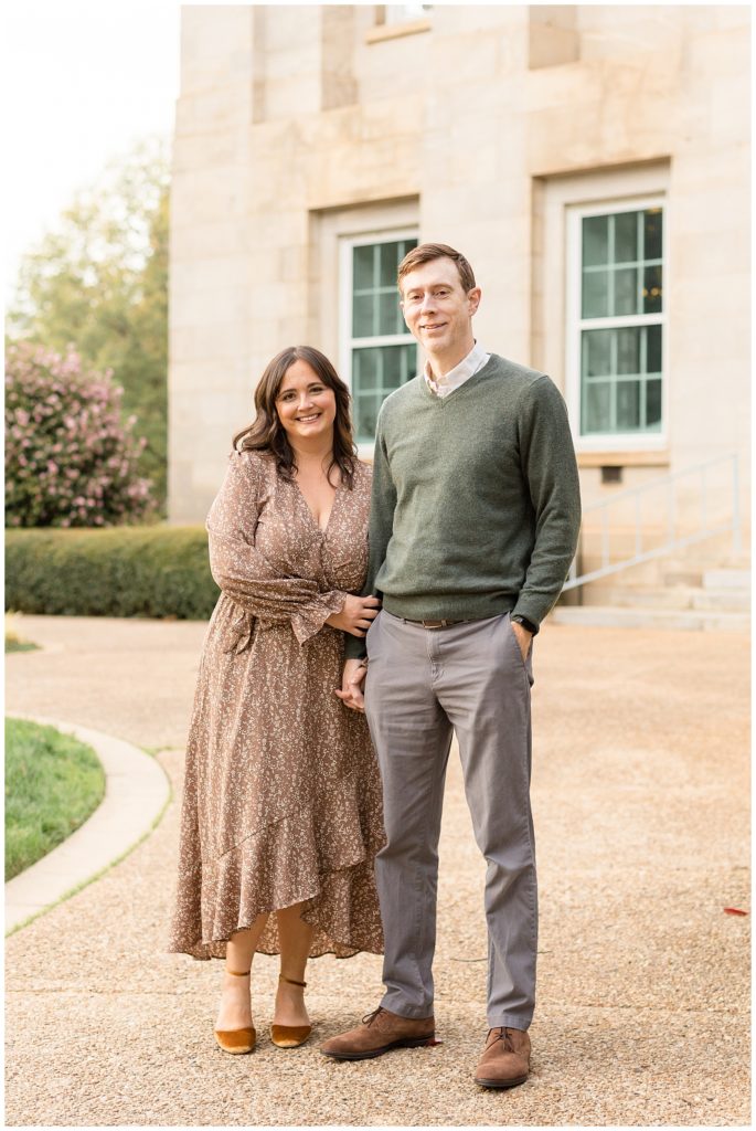 Husband and wife wear coordinating fall colors of brown and green and grey for their family photography session in downtown Raleigh, NC.  Check out the blog to see more of our mini-sessions!