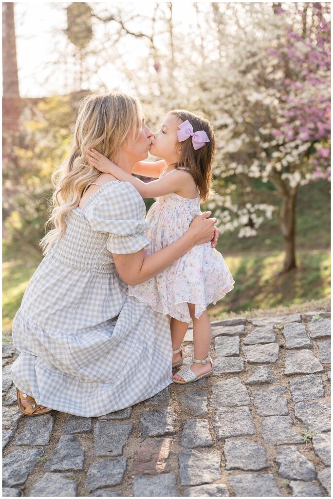 Little girl gives mom a kiss during their spring family portrait session Richmond, VA.