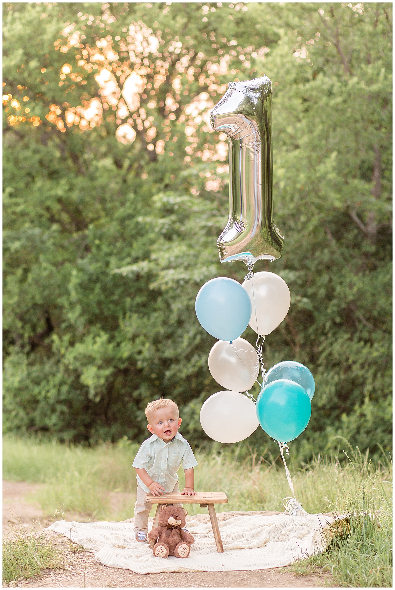 First birthday with blue and white balloons captured by Texas family photographer, Wisp + Willow Photography Co.