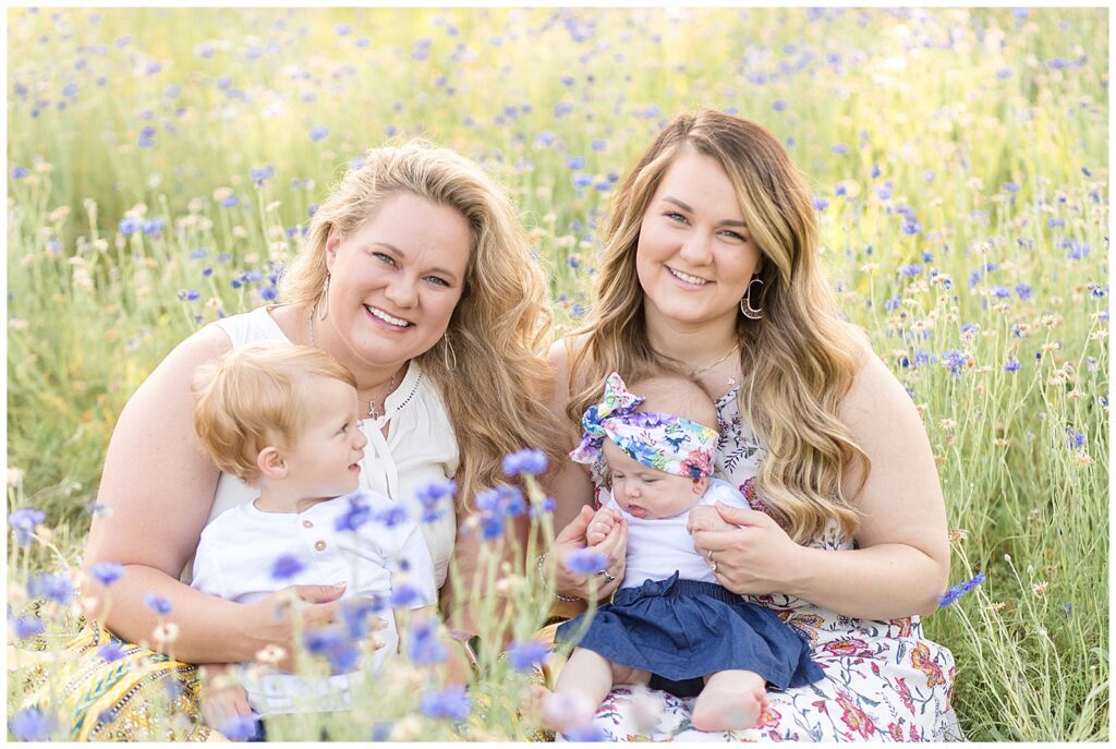 Sister coordinate babies in white, denim, and floral during their mini session in Richardson, TX.