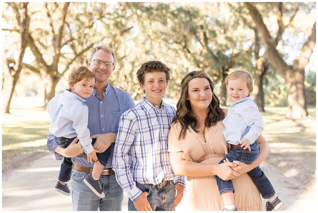 Family of 5 smile at Wisp + Willow Photography Co. during their fall mini session in Savannah, GA.